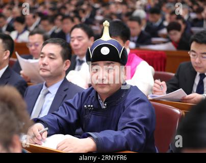 (180318) -- BEIJING, March 18, 2018 -- Wu Yunbo, a newly-elected deputy to the 13th National People s Congress (NPC), attends the opening meeting of the first session of the 13th NPC at the Great Hall of the People in Beijing, capital of China, March 5, 2018. Wu Yunbo of Mongolia ethnic group comes from Dongsala Village of Jarud Qi (County) of north China s Inner Mongolia Autonomous Region. As a secretary of the Communist Party of China local branch in the Dongsala Village, he initiated a cooperative in 2013 and explored a way to get people out of poverty. Farmers and herdsmen were encouraged Stock Photo