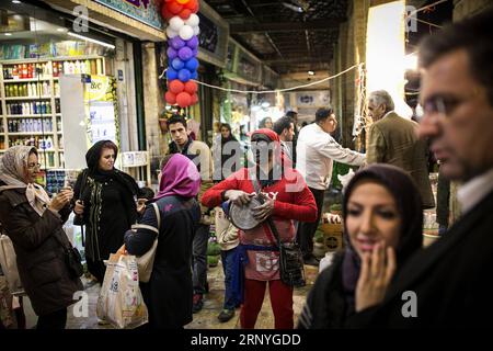 (180319) -- TEHRAN, March 19, 2018 -- A man (C) dressed as a Haji Firouz, a traditional character who appears in streets by the beginning of Iranian new year, sings and play music in Tajrish bazaar in Tehran, Iran, on March 18, 2018, ahead of Nowruz, the Iranian New Year. Nowruz marks the first day of spring and the beginning of the year in Iranian calendar. )(gj) IRAN-TEHRAN-NEW YEAR SHOPPING AhmadxHalabisaz PUBLICATIONxNOTxINxCHN Stock Photo