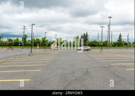 lone car parked in a large parking lot. Stock Photo