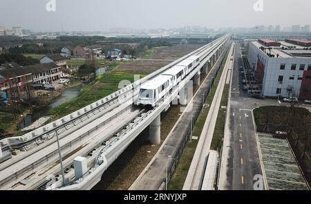 (180324) -- SHANGHAI, March 24, 2018 -- Aerial photo taken on March 23, 2018 shows a subway train running on the first APM line, or the Automated People Mover system, in Shanghai, east China. A new metro line with driverless trains is expected to be tested by the end of March in Shanghai, the Shanghai Shentong Metro Group announced on Friday. ) (zwx) CHINA-SHANGHAI-APM-TRIAL RUN (CN) DingxTing PUBLICATIONxNOTxINxCHN Stock Photo