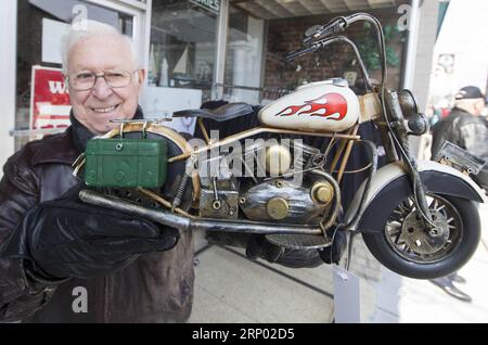(180414) -- PORT DOVER, April 14, 2018 -- A man shows a motorcycle model during the 13th Motorcycle Rally in Port Dover, Ontario, Canada, on April 13, 2018. The traditional event is held every Friday the 13th in the small southwestern Ontario town since 1981.) (yy) CANADA-PORT DOVER-FRIDAY THE 13TH-MOTORCYCLE RALLY zouxzheng PUBLICATIONxNOTxINxCHN Stock Photo