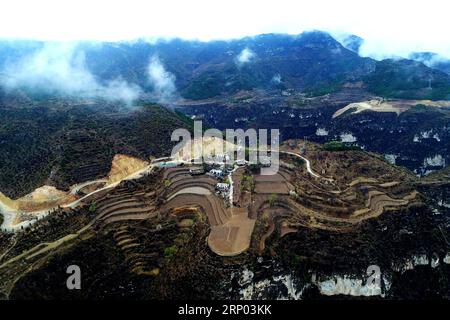 (180416) -- PINGSHUN, April 16, 2018 -- Aerial photo taken on April 13, 2018 shows the bird-eye view of an unincorporated village Qingcaojie of Luya village in Pingshun County, Changzhi City of north China s Shanxi Province. On Sunday morning, Wang Xiugen and his wife packed all their stuff, moved out of the old house, headed to their new home at the foot of the Taihang mountains. Due to the remoteness of the mountainous area, they used to live a tough life with very few farming fields and much trouble of not just transportation. Wang s family is among more than 300 villagers living in the reg Stock Photo