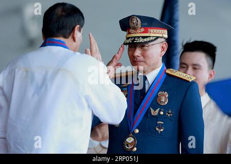 (180419) -- QUEZON CITY, April 19, 2018 -- Philippine President Rodrigo Duterte (L) is greeted by Oscar Albayalde, the new head of the Philippine National Police (PNP), during PNP s command handover ceremony inside Camp Crame in Quezon City, the Philippines, April 19, 2018. Philippine President Rodrigo Duterte named Oscar Albayalde as the new head of the PNP on April 5 and the command handover ceremony was held here on Thursday. ) (zjl) PHILIPPINES-QUEZON CITY-PNP-COMMAND-HANDOVER RouellexUmali PUBLICATIONxNOTxINxCHN Stock Photo