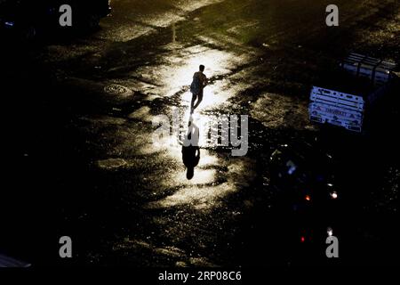 (180425) -- CAIRO, April 25, 2018 -- A pedestrian walks in the rain in Cairo, Egypt, on April 25, 2018. Several parts of Cairo and Giza witnessed heavy rainfall with lightning and thunder on Wednesday. ) EGYPT-CAIRO-HEAVY RAIN AhmedxGomaa PUBLICATIONxNOTxINxCHN Stock Photo