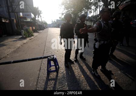 (180509) -- DEPOK, May 9, 2018 -- Officers stand guard outside the headquarters of Mobile Brigade, an elite Indonesian police forces, following a riot at the detention center inside the compound in Depok, West Java, Indonesia, on May 9, 2018. Militants killed five members of an anti-terror squad and is taking another hostage in a prison riot in the outskirts of the capital Jakarta, police said on Wednesday. ) (zjl) INDONESIA-DEPOK-PRISON RIOT AgungxKuncahyaxB. PUBLICATIONxNOTxINxCHN Stock Photo