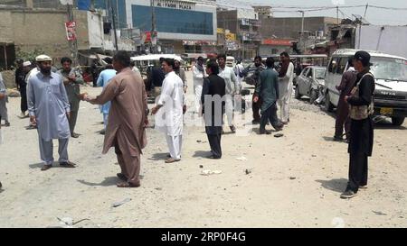 (180511) -- BANNU, May 11, 2018 -- People gather at the blast site in northwest Pakistan s Bannu on May 11, 2018. A policeman was killed and 13 others were injured when a remote-controlled bomb went off near a police vehicle in Pakistan s northwestern Khyber Pakhtunkhwa province on Friday, police said. ) (zxj) PAKISTAN-BANNU-BLAST Stringer PUBLICATIONxNOTxINxCHN Stock Photo