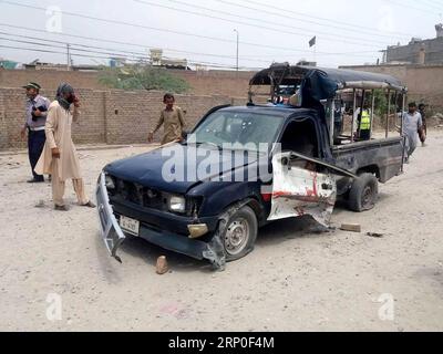 (180511) -- BANNU, May 11, 2018 -- People gather around a damaged police vehicle at the blast site in northwest Pakistan s Bannu on May 11, 2018. A policeman was killed and 13 others were injured when a remote-controlled bomb went off near a police vehicle in Pakistan s northwestern Khyber Pakhtunkhwa province on Friday, police said. ) (zxj) PAKISTAN-BANNU-BLAST Stringer PUBLICATIONxNOTxINxCHN Stock Photo