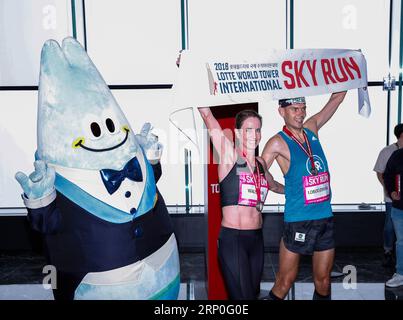 (180513) -- SEOUL, May 13, 2018 -- Polish runner Piotr Lobodzinski (R) and Australian runner Suzy Walsham celebrate after winning the men s and women s category respectively in the Lotte World Tower International Skyrun 2018 in Seoul, South Korea, on May 13, 2018. Runners raced up the 123-floor, 2,917-step, 555-meter-high skyscraper, South Korea s tallest of the kind, on Sunday. ) (SP)SOUTH KOREA-SEOUL-SKYRUN WangxJingqiang PUBLICATIONxNOTxINxCHN Stock Photo