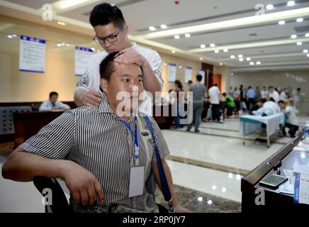 (180517) -- XI AN, May 17, 2018 -- A blind shows massage skills during a job fair for the handicapped in Xi an, capital of northwest China s Shaanxi Province, May 17, 2018. A job fair for the handicapped was held here on Thursday, during which 685 job vacancies and 185 free training chances were offered. ) (zwx) CHINA-SHAANXI-JOB FAIR FOR THE HANDICAPPED (CN) LiuxXiao PUBLICATIONxNOTxINxCHN Stock Photo