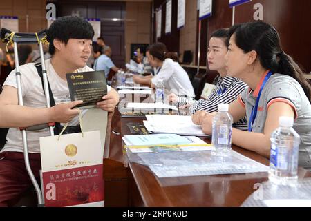 (180517) -- XI AN, May 17, 2018 -- People enquire for information during a job fair for the handicapped in Xi an, capital of northwest China s Shaanxi Province, May 17, 2018. A job fair for the handicapped was held here on Thursday, during which 685 job vacancies and 185 free training chances were offered. ) (zwx) CHINA-SHAANXI-JOB FAIR FOR THE HANDICAPPED (CN) LiuxXiao PUBLICATIONxNOTxINxCHN Stock Photo