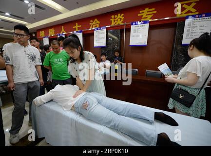 (180517) -- XI AN, May 17, 2018 -- A job hunter shows massage skills during a job fair for the handicapped in Xi an, capital of northwest China s Shaanxi Province, May 17, 2018. A job fair for the handicapped was held here on Thursday, during which 685 job vacancies and 185 free training chances were offered. ) (zwx) CHINA-SHAANXI-JOB FAIR FOR THE HANDICAPPED (CN) LixYibo PUBLICATIONxNOTxINxCHN Stock Photo