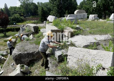 (180523) -- BEIJING, May 23, 2018 -- Staff members clean up weeds at ruins of Yuanying Guan (Immense Ocean Observatory) at Yuanmingyuan in Beijing, capital of China, May 23, 2018. The four-month reinforcement project of ruins of Immense Ocean Observatory at the historical site of Yuanmingyuan started lately. )(ly) CHINA-BEIJING-YUANMINGYUAN-IMMENSE OCEAN OBSERVATORY-REINFORCEMENT & PROTECTION (CN) LuoxXiaoguang PUBLICATIONxNOTxINxCHN Stock Photo