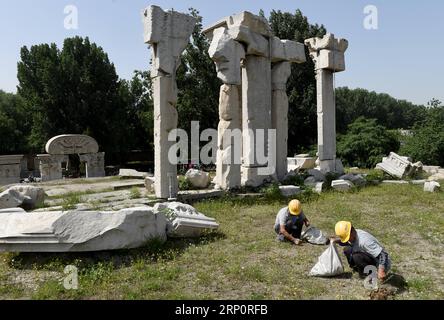 (180523) -- BEIJING, May 23, 2018 -- Staff members clean up weeds at ruins of Yuanying Guan (Immense Ocean Observatory) at Yuanmingyuan in Beijing, capital of China, May 23, 2018. The four-month reinforcement project of ruins of Immense Ocean Observatory at the historical site of Yuanmingyuan started lately. )(ly) CHINA-BEIJING-YUANMINGYUAN-IMMENSE OCEAN OBSERVATORY-REINFORCEMENT & PROTECTION (CN) LuoxXiaoguang PUBLICATIONxNOTxINxCHN Stock Photo