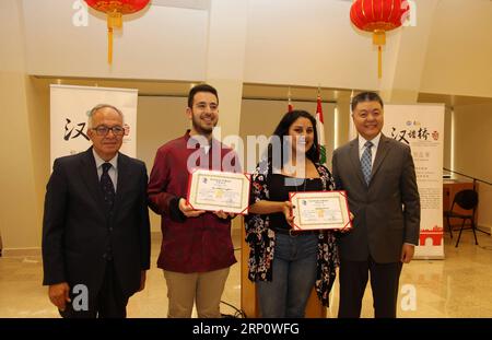 (180526) -- BEIRUT, May 26, 2018 -- Chinese Ambassador to Lebanon Wang Kejian (1st R) and local director of the Confucius Institute at Saint-Joseph University Antoine Hokayem (1st L) pose for photos with winners of the preliminary round competition of Chinese Bridge in Beirut, Lebanon, May 26, 2018. The preliminary round of the 17th Chinese Bridge in Lebanon, or the Chinese proficiency competition for foreign college students, was held Saturday at the Confucius Institute at Saint-Joseph University in Beirut, with participation of 11 competitors. ) LEBANON-BEIRUT-CHINESE BRIDGE-COMPETITION Lixl Stock Photo