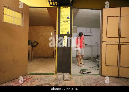 (180527) -- ATHENS, May 27, 2018 -- The owner wipes the debris in one of the two specially arranged rooms at the first Rage Room in Athens, Greece, May 25, 2018. An anger room in Athens designed for stressed-out people to relieve their tension by smashing televisions, keyboards, plates and other objects is now open to public. )(srb) GREECE-ATHENS-RAGE ROOM ChrisxKissadjekian PUBLICATIONxNOTxINxCHN Stock Photo