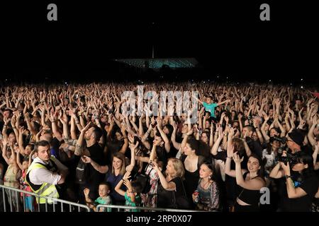 (180527) -- ATHENS, May 27, 2018 -- Fans attend the concert of Locomondo, one of the most successful bands in Greece, at Stavros Niarchos Foundation Cultural Center in Athens, Greece, May 26, 2018. With a great party, featuring Locomondo, one of the most successful bands in Greece, Stavros Niarchos Foundation Cultural Center (SNFCC) welcomed the summer. More than 10,000 people showed up on Saturday evening at the Great Lawn of the park in Faliro Athens by the seaside to dance and sing with their favorite Greek band.) (djj) TO GO WITH XINHUA STORY: Athens residents welcome summer with outdoor c Stock Photo