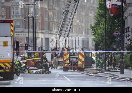 (180606) -- LONDON, June 6, 2018 -- Firefighters and emergency services staff work at the scene after a fire broke out at Mandarin Oriental Hotel in London s Knightsbridge, Britain, on June 6, 2018. A total of 20 fire engines and 120 firefighters and officers are battling a massive blaze at the Mandarin Oriental Hotel in London s Knightsbridge, London Fire Brigade said Wednesday. ) BRITAIN-LONDON-HOTEL-FIRE StephenxChung PUBLICATIONxNOTxINxCHN Stock Photo