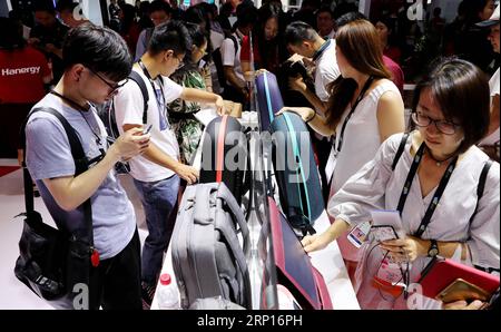 (180613) -- SHANGHAI, June 13, 2018 -- Visitors view backpacks equipped with solar photovoltaic panels during the 2018 CES (Consumer Electronics Show) Asia in Shanghai, east China, June 13, 2018. Nearly 500 companies took part in the CES Asia, which kicked off here on Wednesday. ) (yxb) CHINA-SHANGHAI-CES ASIA (CN) FangxZhe PUBLICATIONxNOTxINxCHN Stock Photo