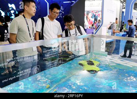 (180613) -- SHANGHAI, June 13, 2018 -- Visitors view a live demonstration of an underwater shooting robot during the 2018 CES (Consumer Electronics Show) Asia in Shanghai, east China, June 13, 2018. Nearly 500 companies took part in the CES Asia, which kicked off here on Wednesday. ) (yxb) CHINA-SHANGHAI-CES ASIA (CN) FangxZhe PUBLICATIONxNOTxINxCHN Stock Photo
