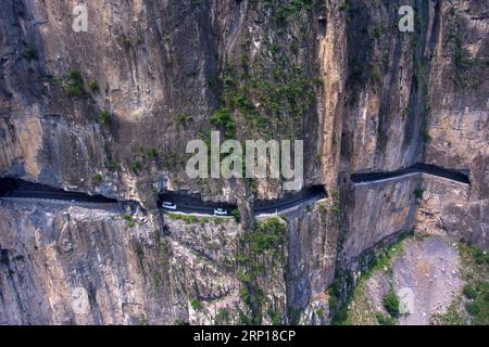 (180617) -- BEIJING, June 17, 2018 -- Aerial photo taken on June 13, 2018 shows cars running on a road in cliffs at Shenlongwan Village in Changzhi City, north China s Shanxi Province. A 1,526-meter-long road was built in the cliffs to connect isolated Shenlongwan to the outside. The construction of this miraculous road lasted for 15 years from 1985 and was built purely by villagers of Shenlongwan. Thanks to this road, villagers now cast off poverty by developing tourism. ) XINHUA PHOTO WEEKLY CHOICES CaoxYang PUBLICATIONxNOTxINxCHN Stock Photo