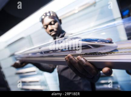 (180617) -- BEIJING, June 17, 2018 -- A railway executive from Ghana watches a model of Fuxing bullet train at a training base for high-speed railway staff in Wuhan, central China s Hubei Province, June 12, 2018. Altogether 63 railway executives from 13 countries visited the training base. ) XINHUA PHOTO WEEKLY CHOICES XiaoxYijiu PUBLICATIONxNOTxINxCHN Stock Photo