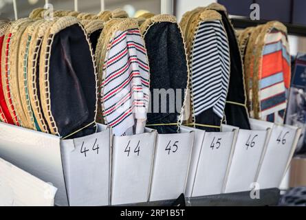 Display of colorful traditional espadrilles, cord and fabric shoes on display at the market in the Old Town of Menton, French Riviera, South of France Stock Photo