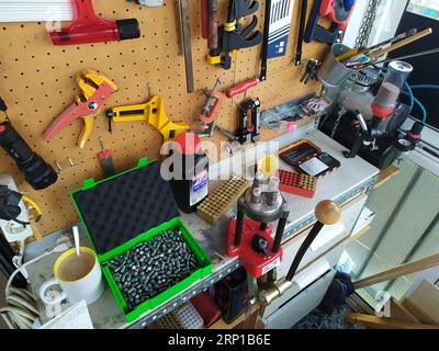 A closeup of the pistol ammunition reloading process Stock Photo