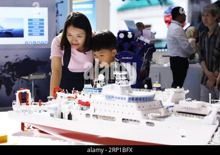 (180623) -- CHONGQING, June 23, 2018 -- Visitors view a ship model at an exhibition held in southwest China s Chongqing Municipality, June 23, 2018. The 9th China International Exhibition of Military and Civil Technologies kicked off Thursday in southwest China s Chongqing Municipality, drawing more than 200 delegations from China and abroad. The number of visitors to the exhibition peaked Saturday. ) (sxk) CHINA-CHONGQING-EXHIBITION-VISIT (CN) WangxQuanchao PUBLICATIONxNOTxINxCHN Stock Photo
