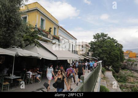 (180624) -- ATHENS, June 24, 2018 -- Locals and tourists walk past coffee shops in downtown Athens, Greece, on June 24, 2018. Greece s coffee industry is rapidly growing, with the coffee lovers widening, according to latest figures from the International Coffee Organization (ICO). ) GREECE-ATHENS-COFFEE INDUSTRY-GROWING LefterisxPartsalis PUBLICATIONxNOTxINxCHN Stock Photo