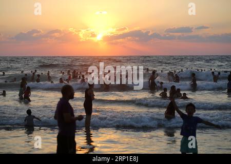 (180629) -- GAZA, June 29, 2018 () -- Palestinians enjoy their leisure time at the Gaza City beach, during the annual summer holiday, June 29, 2018. The tourism industry in the Palestinian Gaza Strip has been suffering a serious decline since Israel and Egypt imposed restrictions on their crossings with the territory that has been ruled by Islamic Hamas movement since 2007. () MIDEAST-GAZA-SEA-TOURISM Xinhua PUBLICATIONxNOTxINxCHN Stock Photo