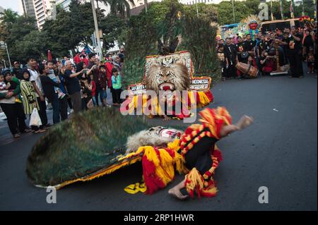 (180708) -- JAKARTA, July 8, 2018 -- Participants with traditional costumes perform on a street during the culture parade of the Jakarta Carnival commemorating the 491st anniversary of Jakarta, in Jakarta, Indonesia, on July 8, 2018. ) (dtf) INDONESIA-JAKARTA-CARNAVAL-PARADE VerixSanovri PUBLICATIONxNOTxINxCHN Stock Photo