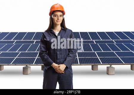 Young female technician with a helmet and goggles posing in front of photovoltaics isolated on white background Stock Photo