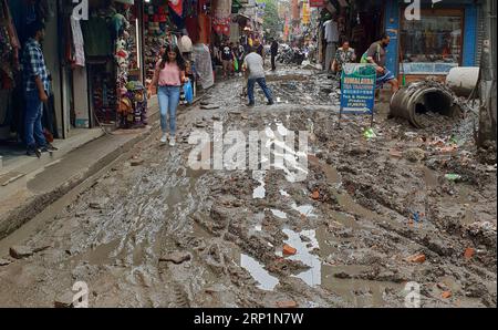 (180716) -- KATHMANDU, July 16, 2018 -- People walk across a muddy road after rainfall in Kathmandu, Nepal, on July 15, 2018. ) (dtf) NEPAL-KATHMANDU-MONSOON RAINFALL sunilxsharma PUBLICATIONxNOTxINxCHN Stock Photo