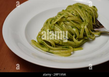Trenette or Linguine Pasta with Green Pesto alla Genovese with Basil Stock Photo