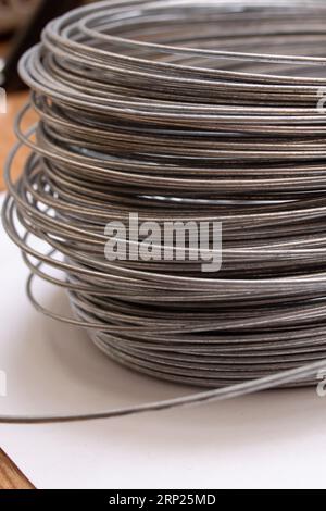 Large coil of wire on the table close up Stock Photo