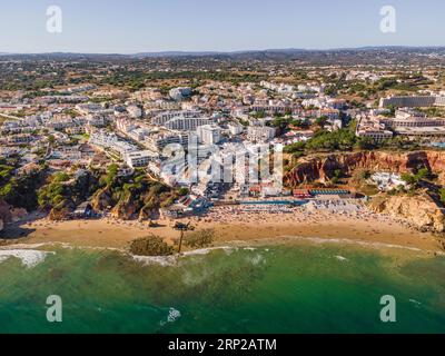 The waves of the Atlantic Ocean crash on the beach of Olhos de Agua in the Portuguese Algarve in the district of Faro. (Aerial view with a drone) Stock Photo