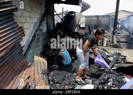 (180828) -- MANILA, Aug. 28, 2018 -- Residents search for their belongings through rubbles after a fire in Manila, the Philippines, Aug. 28, 2018. At least five children are feared dead and two others were injured as fire razed a row of houses in Manila s Tondo district on Monday morning. ) (zxj) PHILIPPINES-MANILA-FIRE-AFTERMATH ROUELLExUMALI PUBLICATIONxNOTxINxCHN Stock Photo