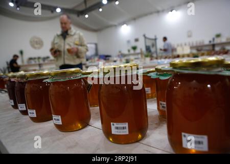 (180904) -- MODI IN, Sept. 4, 2018 -- Israeli workers prepare honey at a honey shop near Modi in, on Sept. 4, 2018. Apples dipped in honey are traditionally eaten on the upcoming holiday of Rosh Hashanah, the Jewish New Year. The Jewish New Year will start at sundown on Sunday, Sept. 9. ) MIDEAST-MODI IN-HONEY-ROSH HASHANAH GilxCohenxMagen PUBLICATIONxNOTxINxCHN Stock Photo