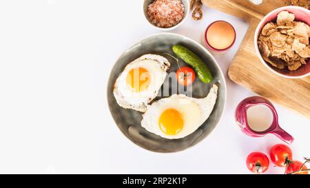 Fried omelette with tomato cucumber plate white background Stock Photo