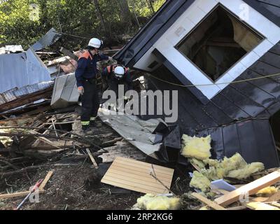 (180906) -- HOKKAIDO, Sept. 6, 2018 -- Rescuers work at a collapsed house after an earthquake in the town of Atsuma, Hokkaido prefecture, Japan, on Sept. 6, 2018. Eight people have likely died, with two confirmed dead and six in a state of cardiopulmonary arrest, Japan s public broadcaster NHK said after a powerful earthquake battered Japan s northernmost prefecture of Hokkaido early Thursday. ) JAPAN-HOKKAIDO-EARTHQUAKE DengxMin PUBLICATIONxNOTxINxCHN Stock Photo