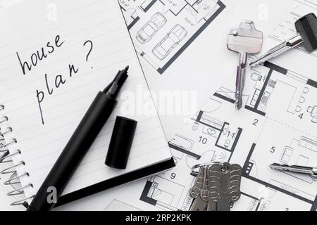House plan with question mark sign written notebook with felt tip pen keys blue print Stock Photo