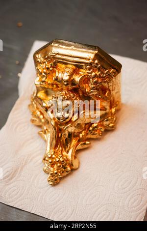 Close-up decorative gold stucco ceiling fillet on the ceiling in ...