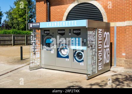 Revolution Laundry outdoor automated launderette.  Located in a Co-Op supermarket car park. Stock Photo