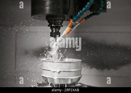 Metalworking CNC machine drilling with coolant. Metal machine industry concept. Stock Photo