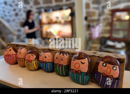 (180917) -- PINGTAN, Sept. 17, 2018 -- Stone-made handicrafts made by Taiwanese are displayed at the art zone of Rocks Can Sing in Beigang Village of Pingtan County, southeast China s Fujian Province, Sept. 7, 2018. When tourists get close to Rocks Can Sing, they may see artists playing music with the rocks, and people sipping coffee in rock houses. Rocks Can Sing is an art project which takes in accommodation, live music, restaurant, cafe and souvenir store. Now, a total of 10 young people from the mainland and Taiwan, including Taiwanese Lin I Chen and her boyfriend Liao Che Wei, work for th Stock Photo