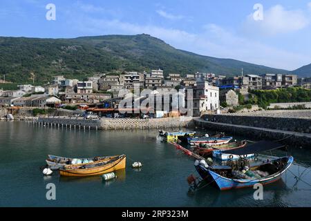 (180917) -- PINGTAN, Sept. 17, 2018 -- Photo taken on Sept. 7, 2018 shows the scenery of Beigang Village in Pingtan County, southeast China s Fujian Province. When tourists get close to Rocks Can Sing, they may see artists playing music with the rocks, and people sipping coffee in rock houses. Rocks Can Sing is an art project which takes in accommodation, live music, restaurant, cafe and souvenir store. Now, a total of 10 young people from the mainland and Taiwan, including Taiwanese Lin I Chen and her boyfriend Liao Che Wei, work for the art project to promote cultural and tourism exchanges a Stock Photo