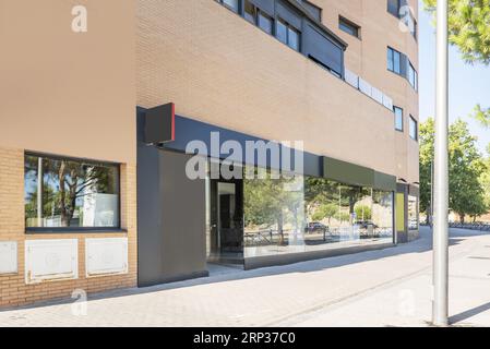 Image of a modern commercial premises at street level with a large glass front on a very bright day Stock Photo