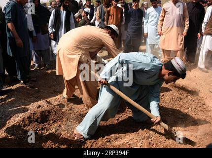 (180926) -- KANDAHAR, Sept. 26, 2018 -- Relatives and friends throw earth on the tomb of Mohammad Nasir Mubaraz, an election candidate for Lower House of parliament election who was killed by gunmen in Kandahar province, Afghanistan, on Sept. 26, 2018. Mohammad Nasir Mubaraz was shot and killed by gunmen in Afghanistan s southern province of Kandahar Tuesday night, a provincial government spokesman said Wednesday. ) (qxy) AFGHANISTAN-KANDAHAR-FUNERAL-ELECTION CANDIDATE SanaullahxSeiam PUBLICATIONxNOTxINxCHN Stock Photo