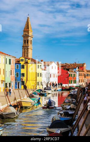 Burano island in the Venetian Lagoon, Municipality of Venice, Italy.  Canal scene with the Leaning Tower of Burano in background.  The campanile, or b Stock Photo