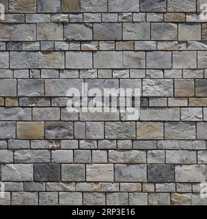 Stone wall / brick wall - evenly spaced grey blocks. Stock Photo